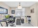 Bright home office features a glass desk, computer, printer, and ample storage at 6505 Stone River Rd # 202, Bradenton, FL 34203