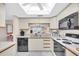 Well-lit kitchen with view into living room at 6505 Stone River Rd # 202, Bradenton, FL 34203
