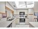Clean kitchen with white cabinets and black appliances at 6505 Stone River Rd # 202, Bradenton, FL 34203