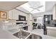 Bright kitchen featuring a skylight and ceiling fan at 6505 Stone River Rd # 202, Bradenton, FL 34203