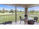 Enjoy serene golf course views from this screened lanai with patio furniture at 6505 Stone River Rd # 202, Bradenton, FL 34203