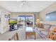 Comfortable living room with sofa, TV, and access to a balcony at 6505 Stone River Rd # 202, Bradenton, FL 34203