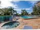 Community pool and spa with lounge chairs at 6505 Stone River Rd # 202, Bradenton, FL 34203