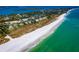 Aerial view of beachfront property with homes and lush landscaping at 6925 Gulf Of Mexico Dr # 24, Longboat Key, FL 34228