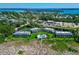 Aerial view showcasing a beachfront community with a pool at 6925 Gulf Of Mexico Dr # 24, Longboat Key, FL 34228