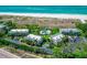 Aerial view of Sea Pines complex, highlighting its buildings, pool, and proximity to the beach at 6925 Gulf Of Mexico Dr # 24, Longboat Key, FL 34228