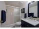 Clean bathroom with navy vanity and shower at 6925 Gulf Of Mexico Dr # 24, Longboat Key, FL 34228