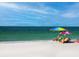 Relaxing beach scene with couple under beach umbrella at 6925 Gulf Of Mexico Dr # 24, Longboat Key, FL 34228