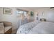 Guest bedroom with coastal decor and wicker chair at 6925 Gulf Of Mexico Dr # 24, Longboat Key, FL 34228