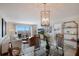 Bright dining room with glass table and coastal decor at 6925 Gulf Of Mexico Dr # 24, Longboat Key, FL 34228