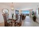 Elegant dining area with glass-top table and ocean view at 6925 Gulf Of Mexico Dr # 24, Longboat Key, FL 34228