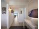 Long hallway with light walls and wood-look floors, leading to living area at 6925 Gulf Of Mexico Dr # 24, Longboat Key, FL 34228