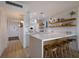 Modern white kitchen with breakfast bar and island at 6925 Gulf Of Mexico Dr # 24, Longboat Key, FL 34228