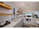 White kitchen with wood shelving, and stainless steel appliances at 6925 Gulf Of Mexico Dr # 24, Longboat Key, FL 34228