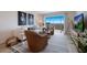 Bright living room with wicker furniture and ocean view at 6925 Gulf Of Mexico Dr # 24, Longboat Key, FL 34228