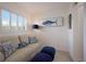 Cozy sitting area with a light beige sofa and blue pillows at 6925 Gulf Of Mexico Dr # 24, Longboat Key, FL 34228