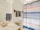 Clean bathroom with shower, striped curtain, and mirror at 709 Barcelona Ave # D & E, Venice, FL 34285