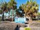 Wooden walkway leads to sandy beach, lifeguard stand in distance at 709 Barcelona Ave # D & E, Venice, FL 34285