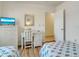 Guest bedroom with white wicker furniture and a desk at 709 Barcelona Ave # D & E, Venice, FL 34285