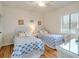 Twin bedroom with white wicker furniture and beach decor at 709 Barcelona Ave # D & E, Venice, FL 34285