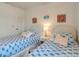 Twin bedroom with white wicker furniture and beach decor at 709 Barcelona Ave # D & E, Venice, FL 34285