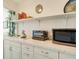 Kitchen features white cabinets, stovetop, and microwave at 709 Barcelona Ave # D & E, Venice, FL 34285