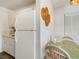 Kitchenette with white cabinets and a full-size refrigerator at 709 Barcelona Ave # D & E, Venice, FL 34285