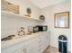 Well-equipped kitchen with white cabinets and appliances at 709 Barcelona Ave # D & E, Venice, FL 34285