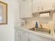 Small kitchen with white cabinets and a stainless steel sink at 709 Barcelona Ave # D & E, Venice, FL 34285