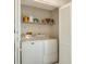 Bright laundry room with washer, dryer, and storage shelves at 709 Barcelona Ave # D & E, Venice, FL 34285