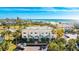 Aerial view of condo community near beach with pool and parking at 7155 Gulf Of Mexico Dr # 22, Longboat Key, FL 34228