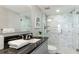 Modern bathroom with gray vanity, marble shower, and white tile at 7155 Gulf Of Mexico Dr # 22, Longboat Key, FL 34228