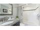 Bathroom with granite countertop, white subway tile, and tub at 7155 Gulf Of Mexico Dr # 22, Longboat Key, FL 34228