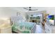 Main bedroom with sliding door to balcony and coastal decor at 7155 Gulf Of Mexico Dr # 22, Longboat Key, FL 34228