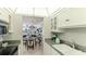 Bright kitchen with granite countertops, stainless steel appliances, and view to dining area at 7155 Gulf Of Mexico Dr # 22, Longboat Key, FL 34228