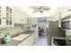 Well-equipped kitchen with granite counters and white cabinets at 7155 Gulf Of Mexico Dr # 22, Longboat Key, FL 34228