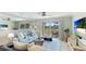 Light and airy living room featuring a sofa and access to balcony at 7155 Gulf Of Mexico Dr # 22, Longboat Key, FL 34228