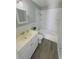 Updated bathroom with white vanity, bathtub, and marble tile at 739 52Nd N Ave, St Petersburg, FL 33703