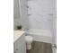 Updated bathroom with white vanity, bathtub, and marble tile at 739 52Nd N Ave, St Petersburg, FL 33703