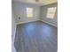 Spacious bedroom with light gray walls and wood-look floors at 739 52Nd N Ave, St Petersburg, FL 33703