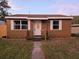 Cute brown house with white trim and well-maintained lawn at 739 52Nd N Ave, St Petersburg, FL 33703