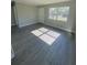 Spacious living room featuring grey vinyl plank flooring and lots of natural light at 739 52Nd N Ave, St Petersburg, FL 33703