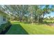Landscaped backyard with mature trees at 770 Egret Walk Ln, Venice, FL 34292