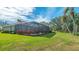 Landscaped backyard with screened patio at 770 Egret Walk Ln, Venice, FL 34292