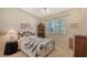 Cozy bedroom with a queen-size bed and wood dresser at 770 Egret Walk Ln, Venice, FL 34292