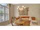 Round dining table with four chairs, located near a window with plantation shutters at 770 Egret Walk Ln, Venice, FL 34292
