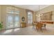 Bright dining room with a round table, chandelier, and large windows at 770 Egret Walk Ln, Venice, FL 34292