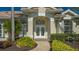 Elegant entryway with double doors and meticulously landscaped gardens at 770 Egret Walk Ln, Venice, FL 34292