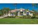 Single-story house with tile roof, landscaped yard, and palm trees at 770 Egret Walk Ln, Venice, FL 34292