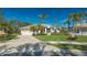 Single-story home with tile roof, attached garage, and landscaped yard at 770 Egret Walk Ln, Venice, FL 34292
